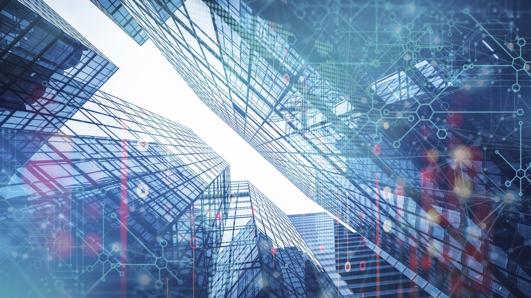 Glass office towers seen from below with a data network overlay